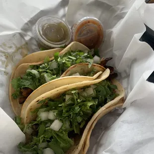 Steak (closest taco) and marinated pork taco