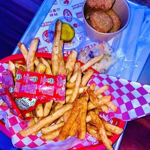 a tray of fried chicken and fries