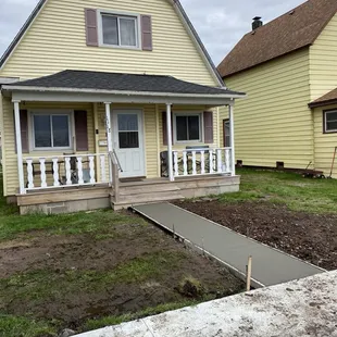 5&apos;x25&apos; sidewalk pad, with rebar 2 running sticks, 2&apos; on center, broom finish and seal.
