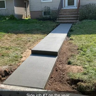 5x35&apos; sidewalk with a 6&quot; step. Rebar doweled into back of curb. Broom finish, tool jointed, sealed.
