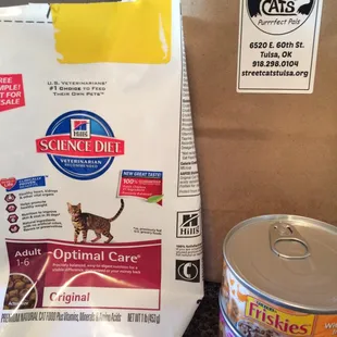 Complimentary Science Diet dry food and 2 cans of Friskies canned food.