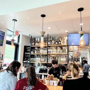 a group of people sitting at a bar