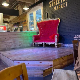 a red chair on a wooden platform