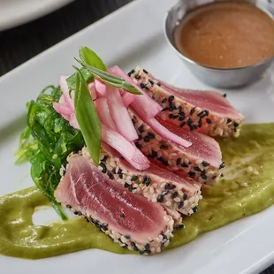 a seared tuna dish on a white plate