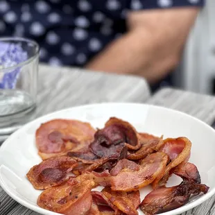 a plate of bacon on a table