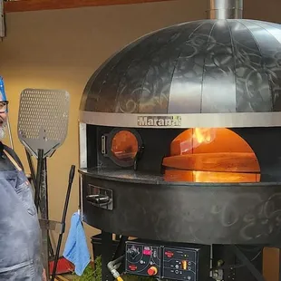 Owner and his amazing pizza oven