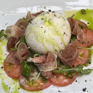 Burrata Appetizer with tomato, prosciutto crudo, arugula and a smoked cracked black pepper