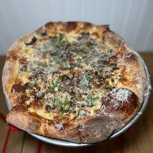 a pizza with cheese and herbs