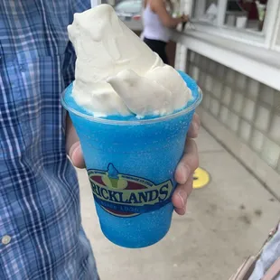 a person holding a cup of ice cream