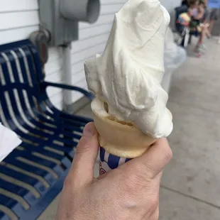 a hand holding an ice cream cone