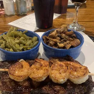 Ribeye with sautéed mushrooms, green beans and grilled shrimp skewer.. glass of Josh Cab