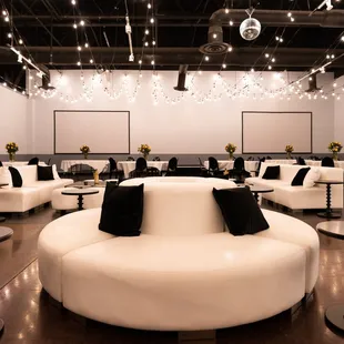 a large room with white furniture