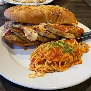 a plate of spaghetti and a sandwich