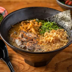 a bowl of ramen with chopsticks