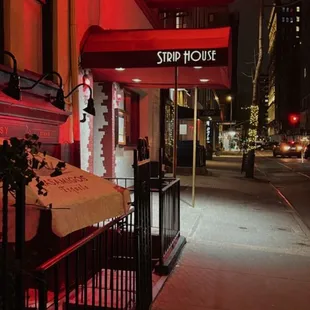 the neon sign for strip house