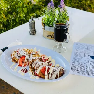 Croissant French Toast served with lemon-cream topping and strawberries