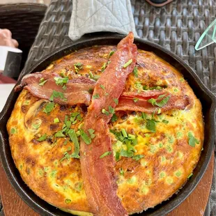 Frittata with 2 strips of bacon on top