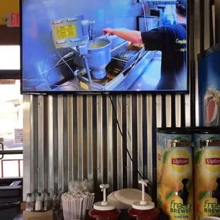 Watch the mini donuts being made on the monitor while you fix your drink