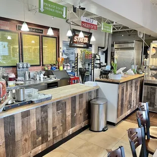 a restaurant with a counter and a bar