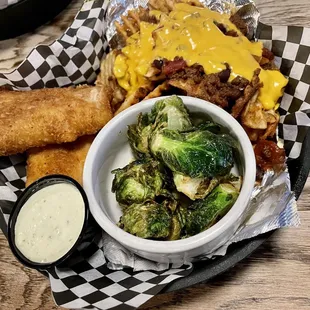 Fish dinner with Fried Brussels Sprouts and waffle fries with chili and cheese