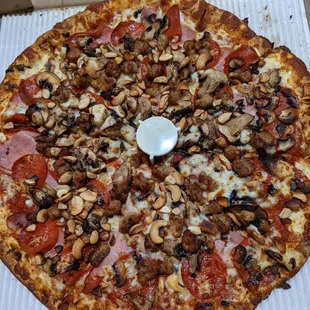 Pepperoni, Ham, Sausage, Mushrooms and Cashews Large thin crust Pizza. Very Good!