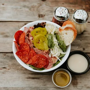 Antipasto salad. Iceberg blend house salad. Pepperoni, salami, prosciutto, black and green olives, banana peppers.