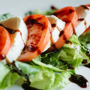 Capri Salad; fresh mozzarella, tomatoes, olive oil, and balsamic drizzle.