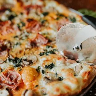a pizza being sliced