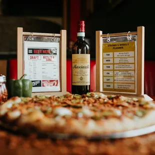 a pizza and a bottle of wine