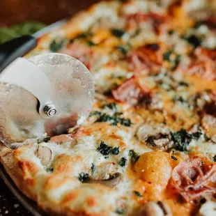 a pizza being sliced