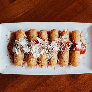 a white plate with a bunch of breadsticks on it