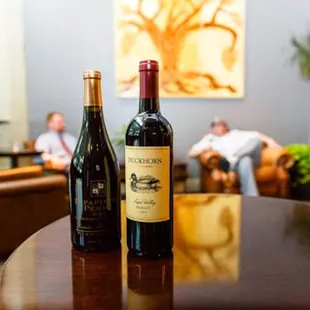 two bottles of wine on a table