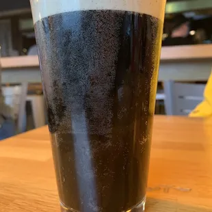 a glass of dark beer