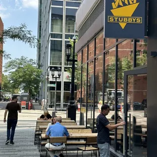 people sitting on benches outside a building