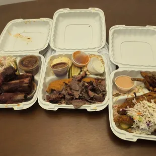 Left to right: Ribs with beans and coleslaw, brisket &amp; catfish with Mac and cheese and potato salad, chicken sandwich with fries.