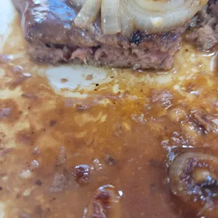 Half cooked chopped steak.