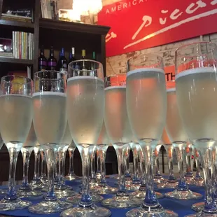 a row of champagne flutes on a table