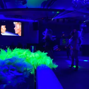 people in a dark room with neon lights