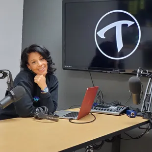 Miss Tee in the Podcast room at Studio T Arts Production Lab