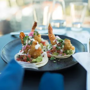 Baja Style Shrimp Tacos  Shrimp, White Corn Tortillas, Pickled Red Onions, Guacamole, Pico de Gallo