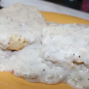 biscuits and gravy on a yellow plate