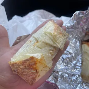 a hand holding a sandwich