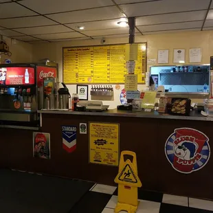 a restaurant counter with a caution sign