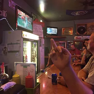 two men sitting at a bar