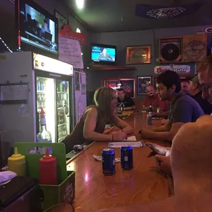 a group of people sitting at a bar