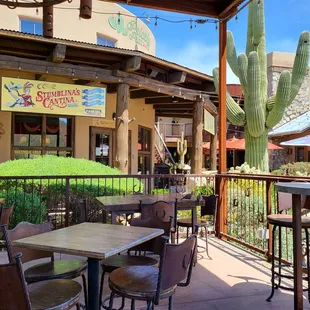 a patio with tables and chairs