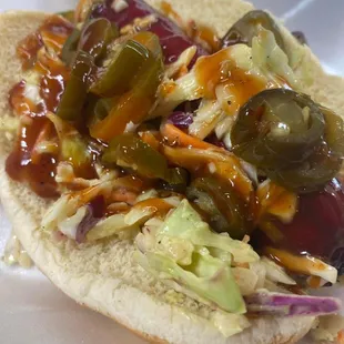 a hot dog with coleslaw and pickles