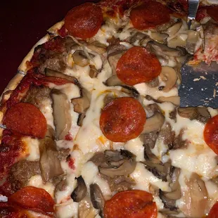 a pizza with pepperoni and mushrooms