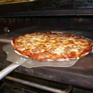 Our stone pizza oven dates back to the 1950&apos;s and still makes the best pies!