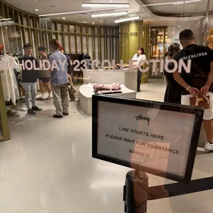 Stand in line to enter the store